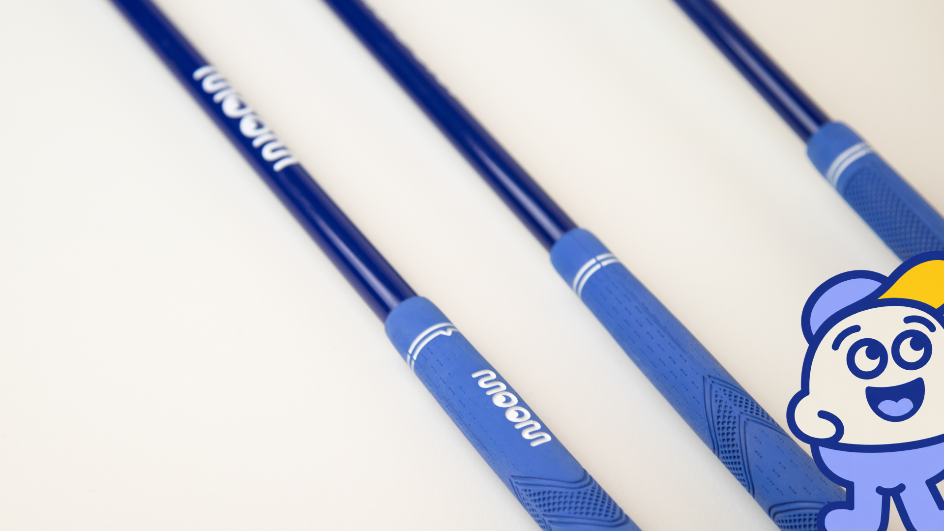 Three blue WOOW kids golf clubs of different lengths side by side
